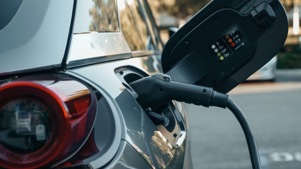 EV charger connector plugged into an electric car's charging port