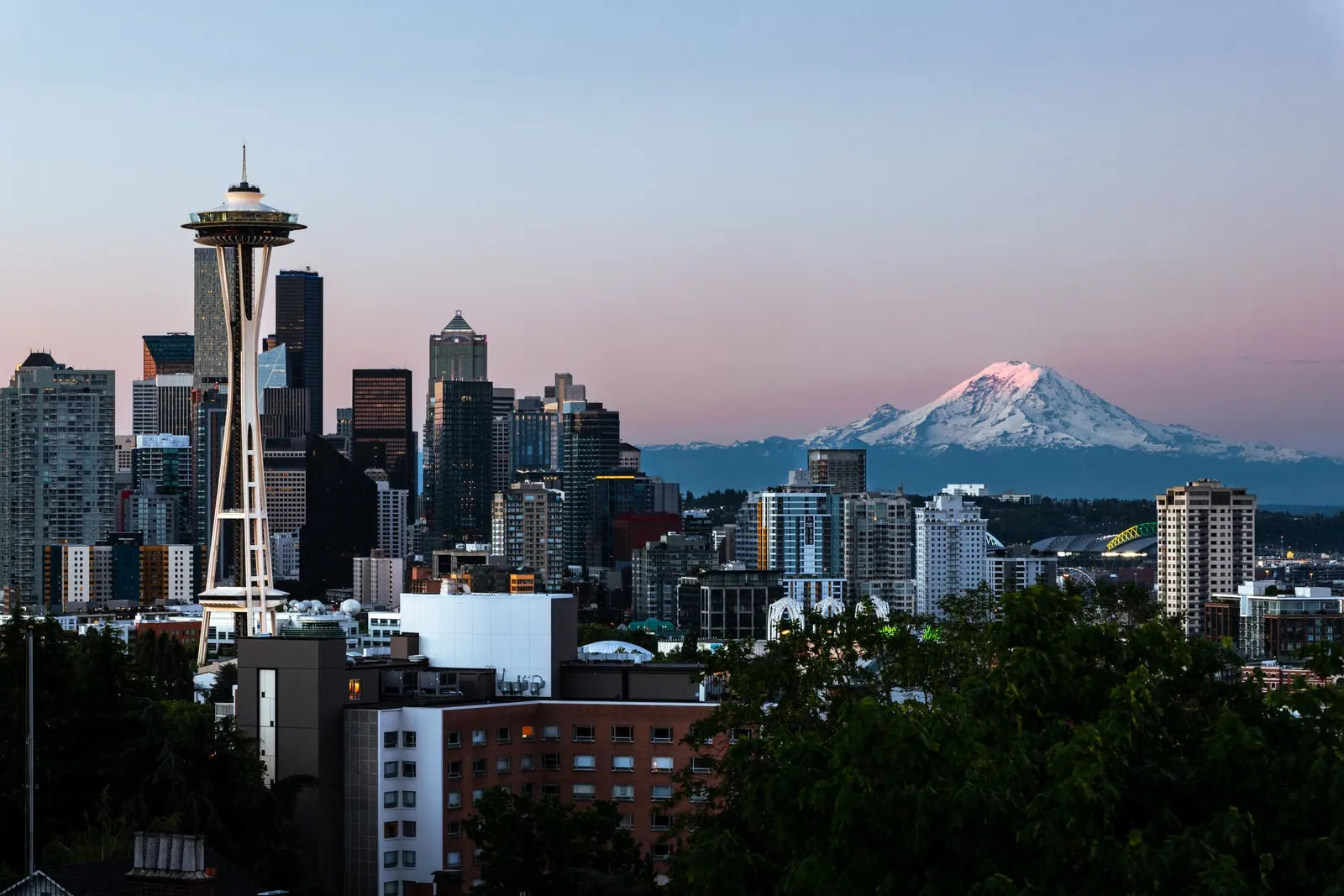 Seattle skyline with the Space Needle and Mount Rainier at dusk
